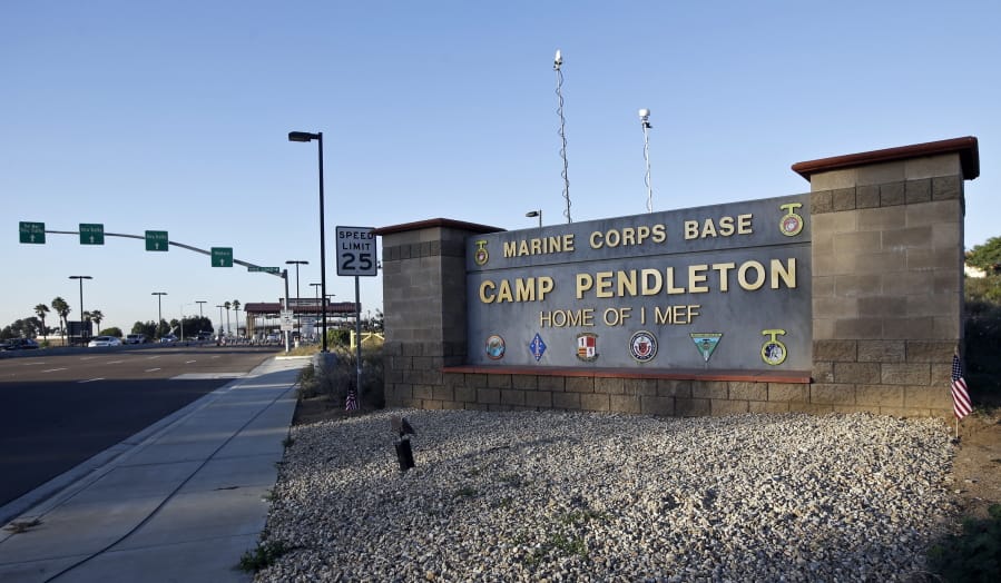 FILE - This Nov. 13, 2013 file photo shows the main gate of Camp Pendleton Marine Base at Camp Pendleton, Calif. A human smuggling investigation by the military led to the arrest of 16 Marines Thursday, July 25, 2019 while carrying out a battalion formation at California’s Camp Pendleton, a base about an hour’s drive from the U.S.-Mexico border.