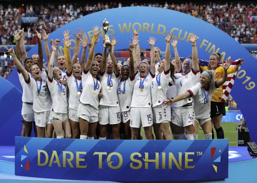 United States’ team celebrates with the trophy after winning the Women’s World Cup on July 7, 2019 in France.