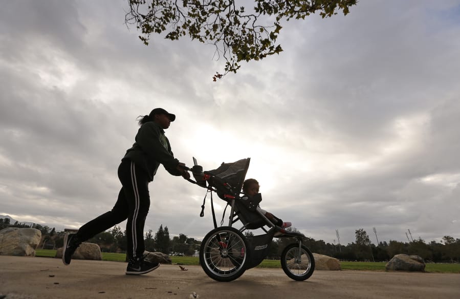 Schannel Strong, with her 9-month-old Jordynn Matthews in the stroller, gets her jog in under foreboding skies on Oct. 3.