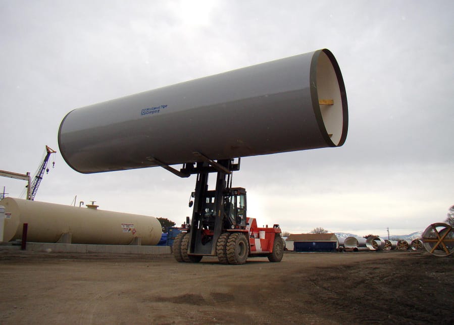 A finished section of pipe is moved by a forklift at a Northwest Pipe Company in Pleasant Grove in February 2011. The pipe was slated to eventually cover the Murdock Canal.