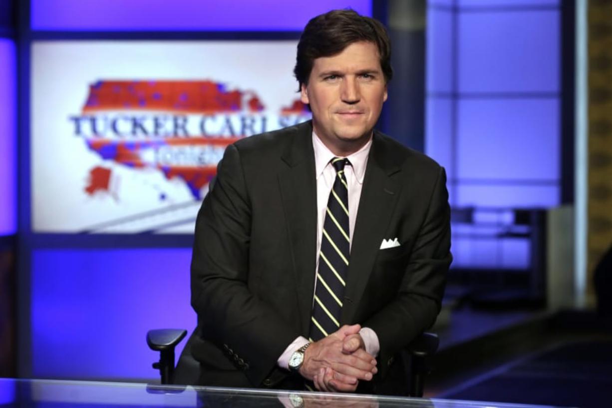 In this March 2, 2017, file photo, Tucker Carlson, host of "Tucker Carlson Tonight," poses for photos in a Fox News Channel studio, in New York. Carlson faced criticism Wednesday, Aug. 7, 2019, for declaring white supremacy "a hoax," the same day President Donald Trump visited El Paso, Texas, after a white gunman who had written an anti-Hispanic rant killed dozens of people.