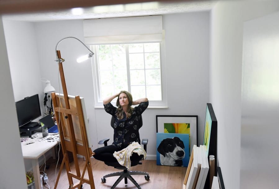 Erica Eriksdotter pauses for a moment while working in her home studio July 28 in Reston, Va.