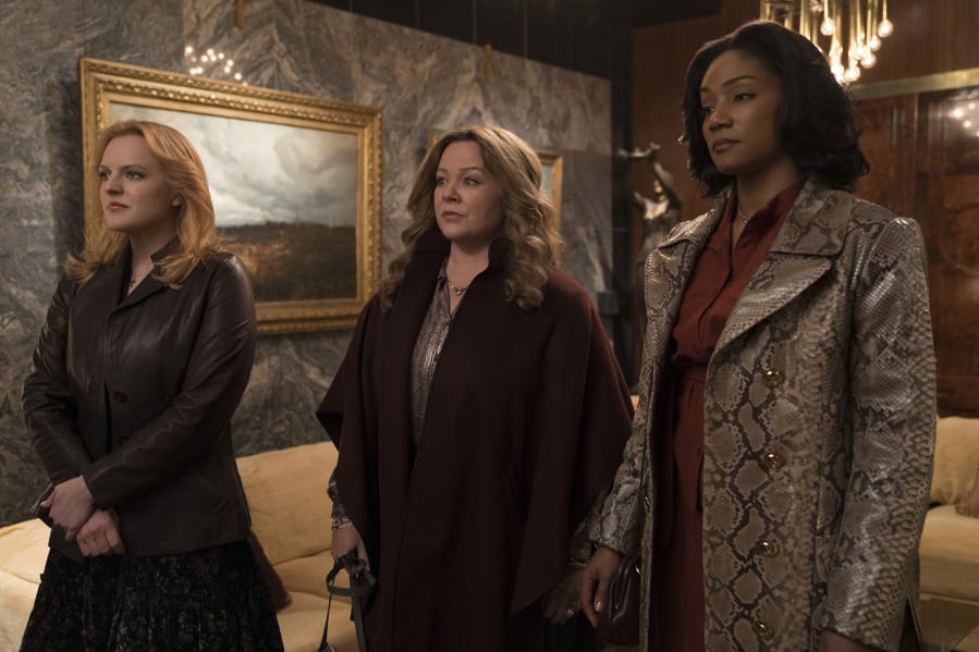 Elisabeth Moss, from left, Melissa McCarthy and Tiffany Haddish in “The Kitchen.” Alison Cohen Rosa/Warner Bros.