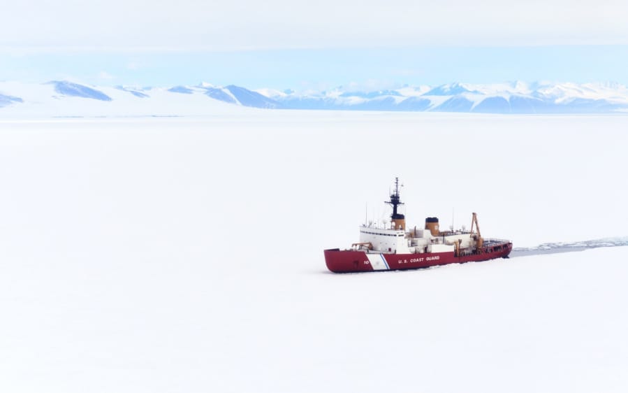 The Coast Guard’s Polar Star breaks ice in Antarctica’s McMurdo Sound, clearing a path for a cargo vessel to deliver supplies for National Science Foundation research bases in 2019. (Nick Ameen/U.S.