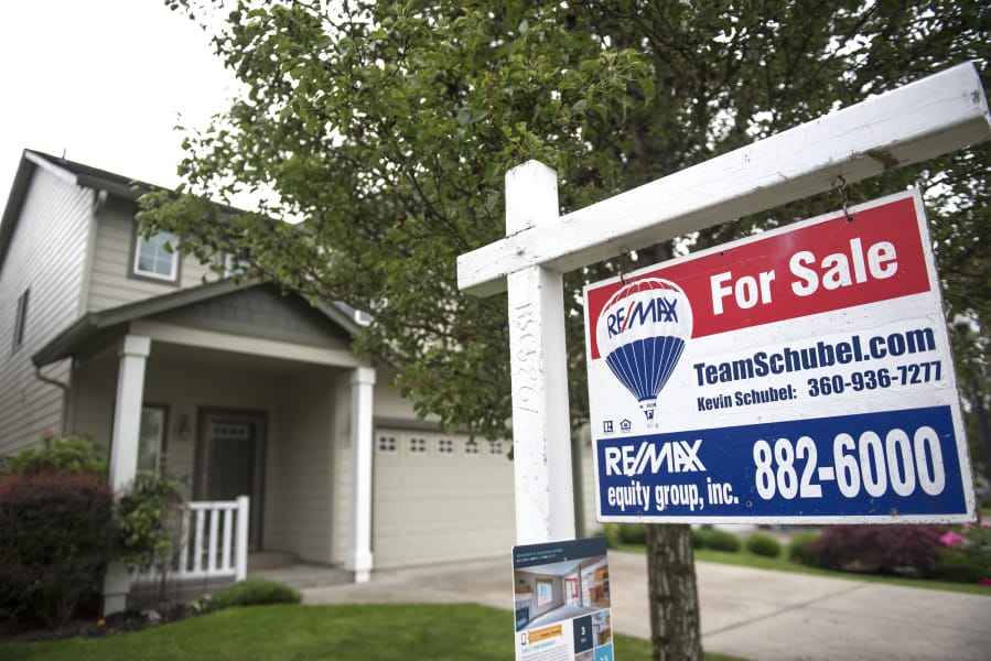 A For Sale sign is seen in front of a home in Felida. Clark County’s housing market grew in July, with more new listings than in any prior month this year. But sales rates climbed as well, keeping the overall inventory in months unchanged.