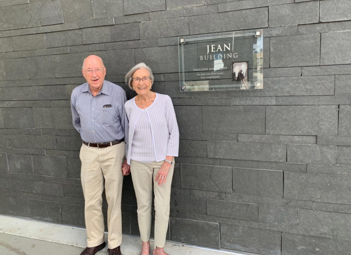 Don and Jean Cain, parents of Gramor Development president Barry Cain, stand next to a dedication plaque on the newly named Jean Building at The Waterfront Vancouver. The Jean Building houses WildFin American Grill.