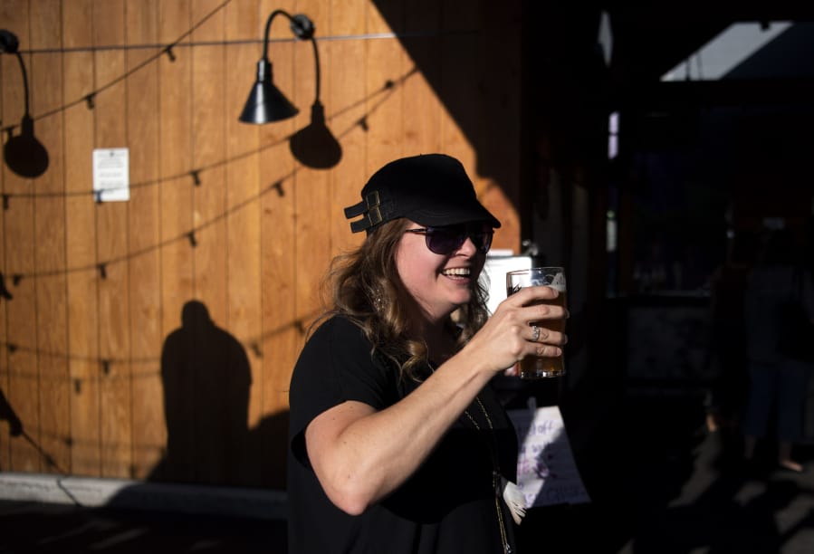Amber Tripp of Reprise Choir toasts a song well sung during the first ’Couve Beer Choir gathering in July at Heathen Brewing Feral Public House. The Beer Choir means to be a just-for-fun monthly event and you pass the audition by just showing up.