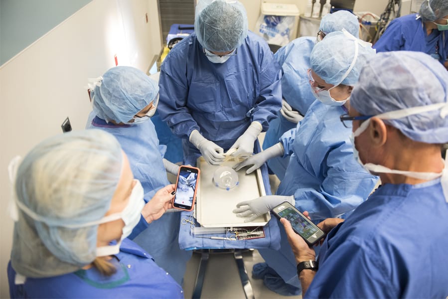 Dr. Patrick Maxwell and Dr. Allen Gabriel work with members of their surgical team to cover a silicon implant with a deep skin graft during a breast reconstruction surgery at Legacy Salmon Creek Medical Center. Maxwell is a highly accomplished plastic surgeon and mentor to Gabriel, a Vancouver plastic surgeon, who was a fellow under him from 2007 to 2008.