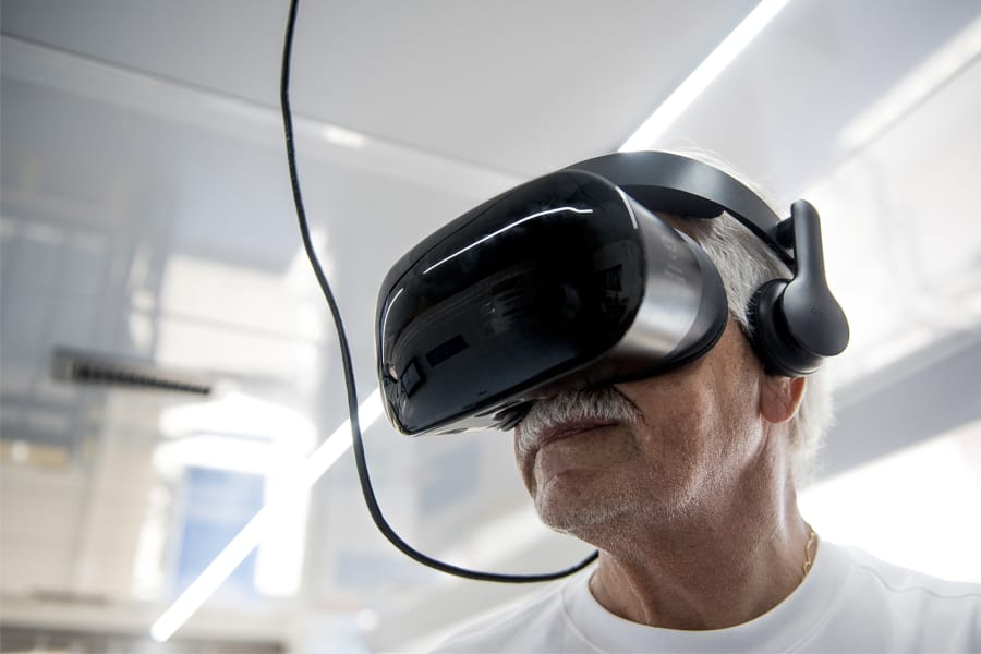 Faiz Humadi, 72, a retired civil engineer originally from Iraq, uses the virtual reality goggles inside the All of Us van in the parking lot of the Grocery Outlet Bargain Market on Fourth Plain Boulevard. The VR goggles teach people about the impact of certain medical breakthroughs.