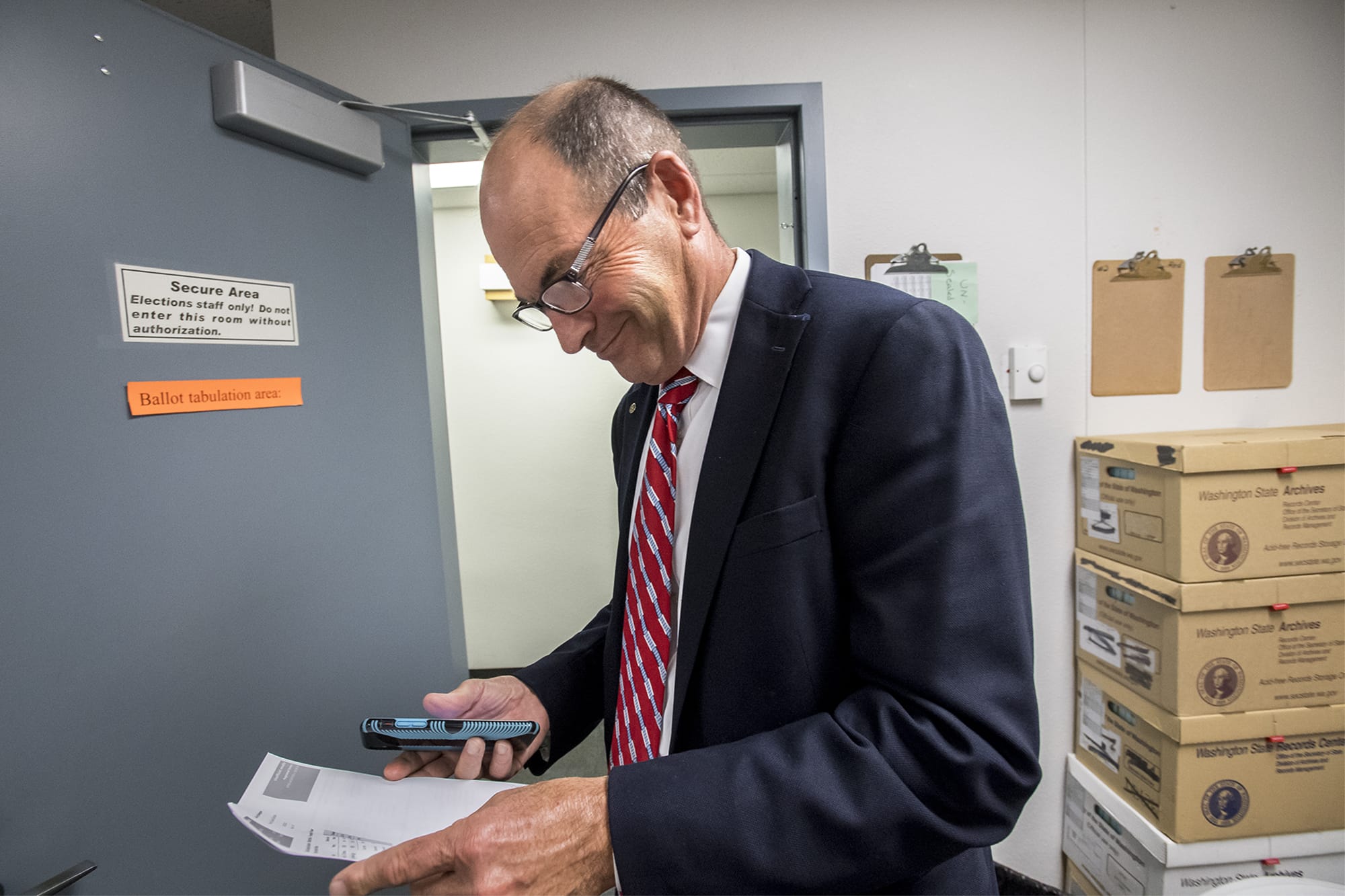 Clark County Auditor Greg Kimsey views the first primary election result printout in the Ballot Tabulation Room of the Clark County Election Office on Tuesday night, Aug. 6, 2019.