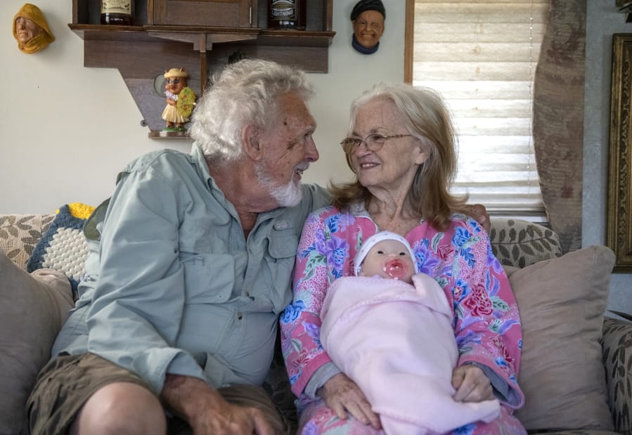Ted St. Mars of Woodland and his wife, MaryAnn, share a quiet moment in their living room, while she holds her doll. MaryAnn St. Mars recently received the baby doll as part of the Hope Dementia Support Group program.