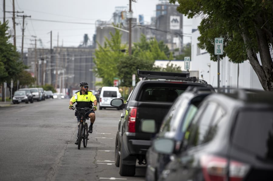 Vancouver Parking Enforcement Officer Tim Brown patrols the streets surrounding the Clark County Courthouse last week. The area around the courthouse gets busy and the officers’ goal, he said, is to create turnover. “We’re not trying to punish people,” he said.