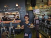 Keyona McDuffie serves lunch to hungry customers while working during the new Stack 571 restaurant’s second full day of business at The Waterfront Vancouver.