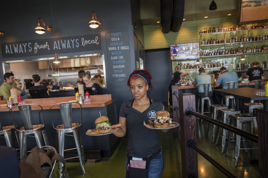 Keyona McDuffie serves lunch to hungry customers while working during the new Stack 571 restaurant’s second full day of business at The Waterfront Vancouver.