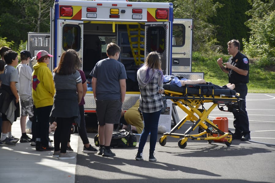 WASHOUGAL: Jemtegaard Middle School students learn from paramedic Andrew Cherry at their annual career fair.