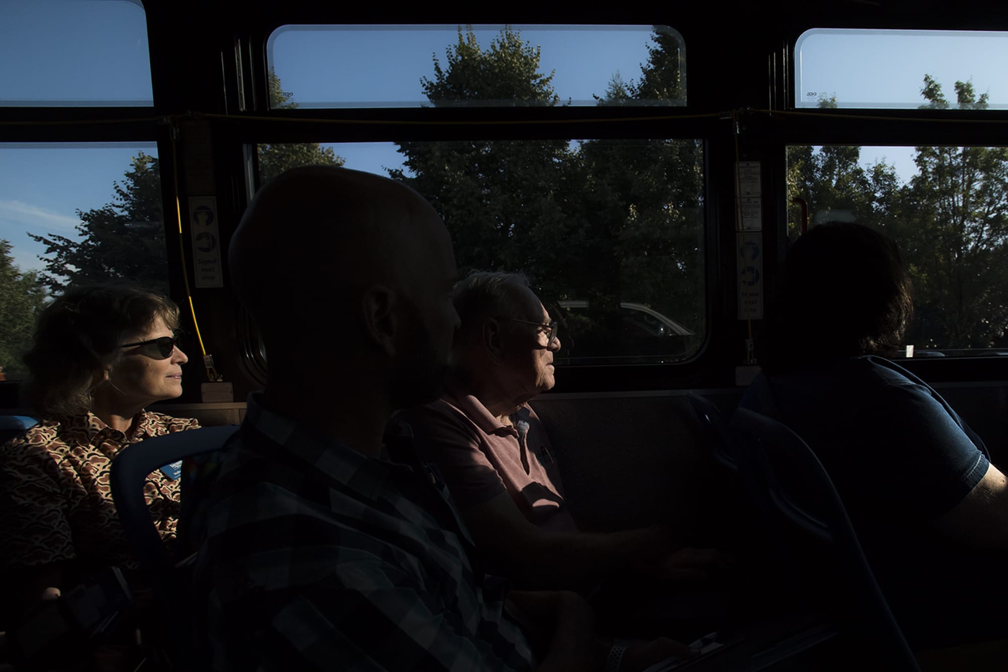 Holly Williams, chair of the Vancouver parks and recreation committee, left, and Paul Lawson, of Vancouver, look out the window of a C-Tran bus during a Vancouver City Council mobile workshop on Monday evening, Aug. 12, 2019.