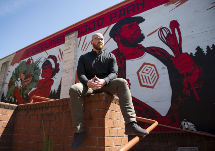Founder Alex Mickle sits in front of a mural at the Columbia Food Park, which recently celebrated the completion of its commercial kitchen.