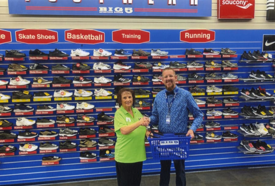 Orchards: Rosann Grzesiowski with the Orchards Evergreen Lions accepts a donation of new shoes from Billy Breece, manager of Big 5 Sporting Goods. The Lions are holding a shoe drive this month for kids at Fircrest Elementary School.
