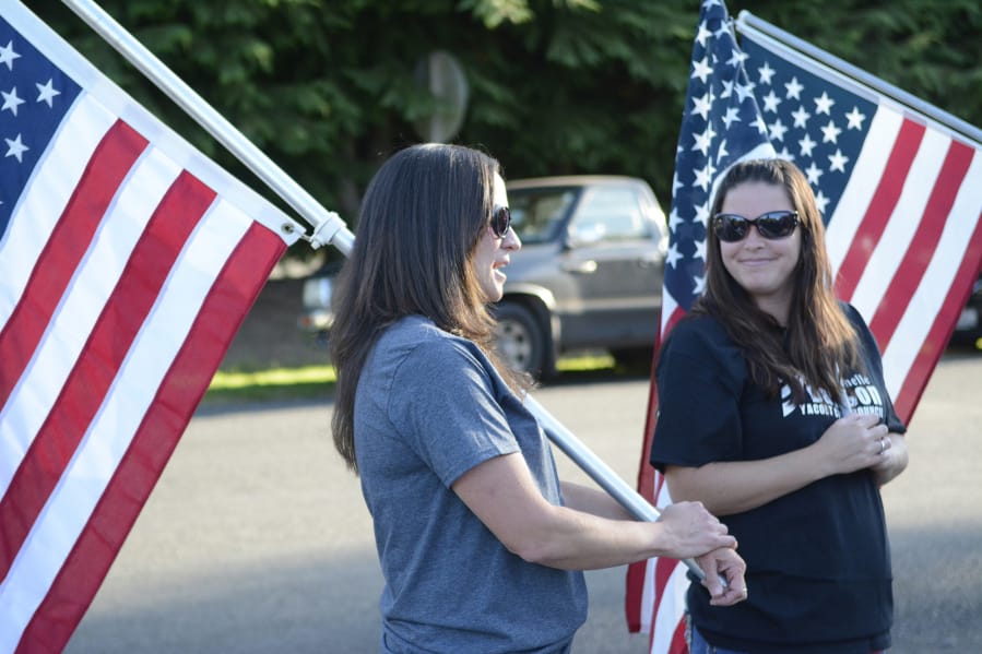 Rhiannon Parks, left, of Battle Ground and Michelle Dawson of Yacolt take part in a rally outside Yacolt Town Hall before Monday’s council meeting. Dawson and supporters had issues with how a recent decision was made to appoint a new town councilor.