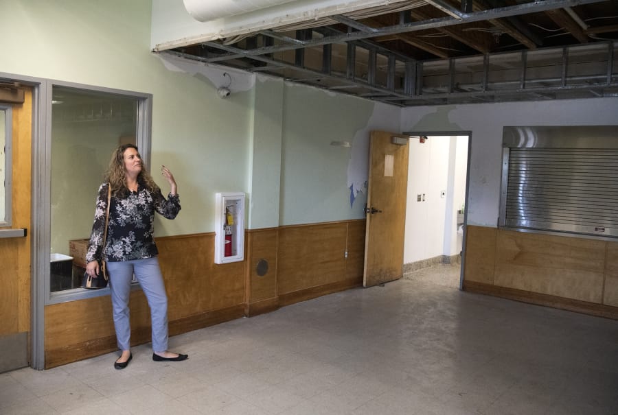 Amy Reynolds, deputy director of Share, stands in the dining room of Share House, which was damaged by fire last month. The dining room and kitchen had just been remodeled last summer.