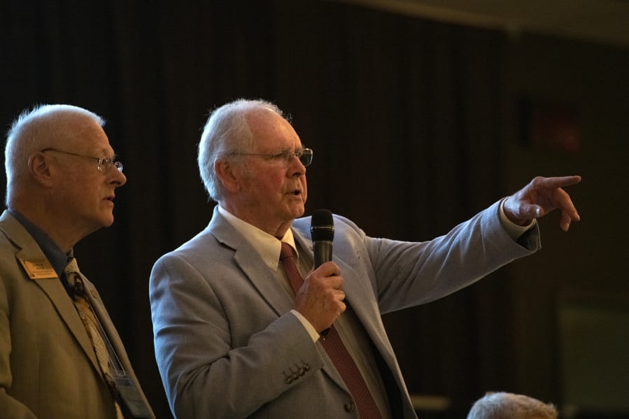 Clark County Republican Party Chair Earl Bowerman, right, acknowledges a speaker during a local Republican Party meeting in August at the Bethesda Church in Vancouver.