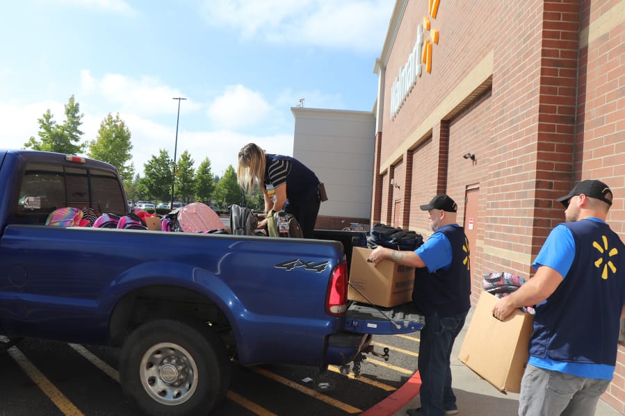 BENNINGTON: Volunteers load backpacks full of school supplies at the 430 S.E. 192nd Ave. Walmart Supercenter. Two-hundred kits were put together for approximately 100 military families in Clark County with a parent deployed or scheduled for deployment.