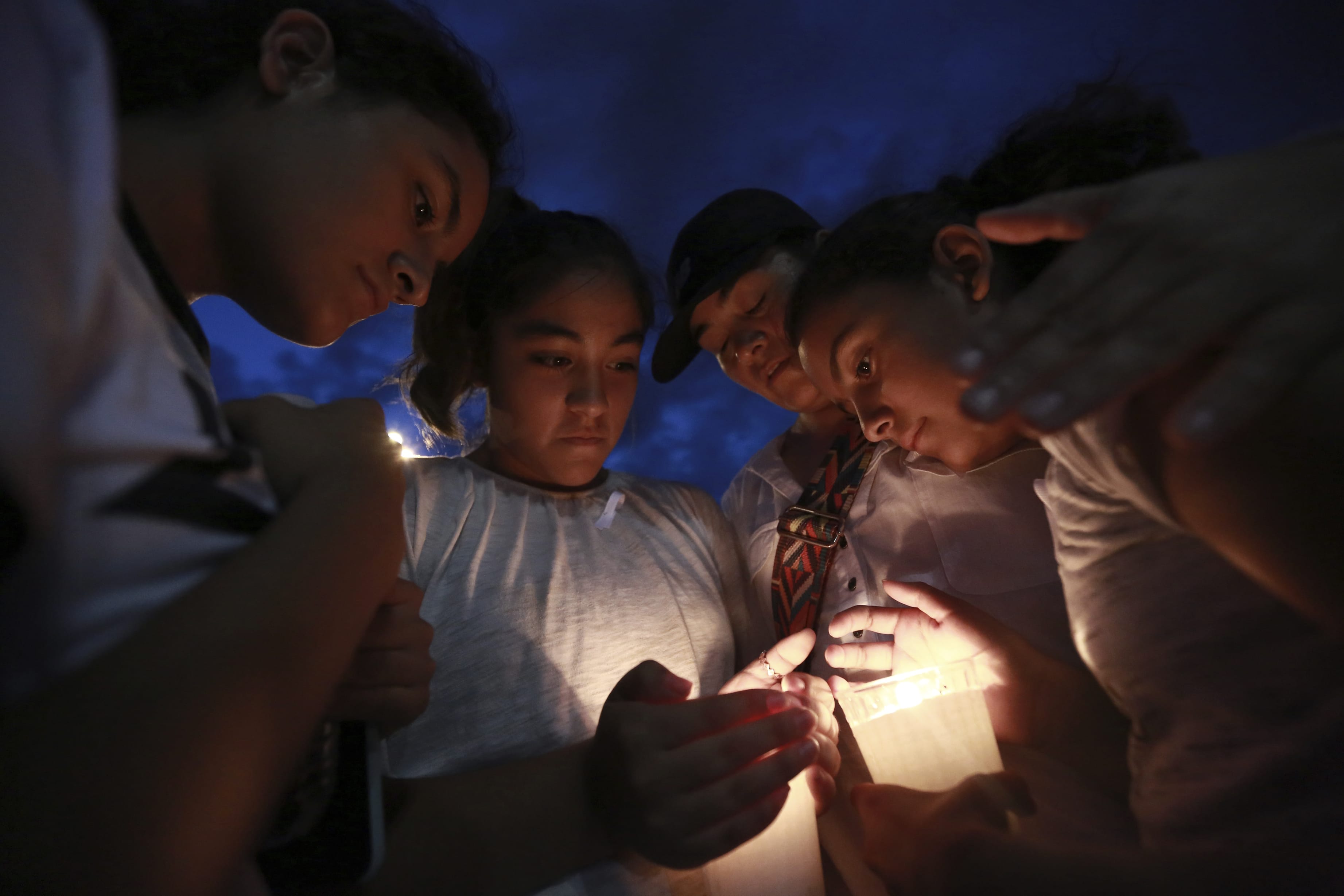 People gather in Juarez, Mexico, Saturday, Aug. 3, 2019, in a vigil for the 3 Mexican nationals who were killed in an El Paso shopping-complex shooting. Twenty people were killed and more than two dozen injured in a shooting Saturday in a busy shopping area in the Texas border town of El Paso, the state’s governor said.