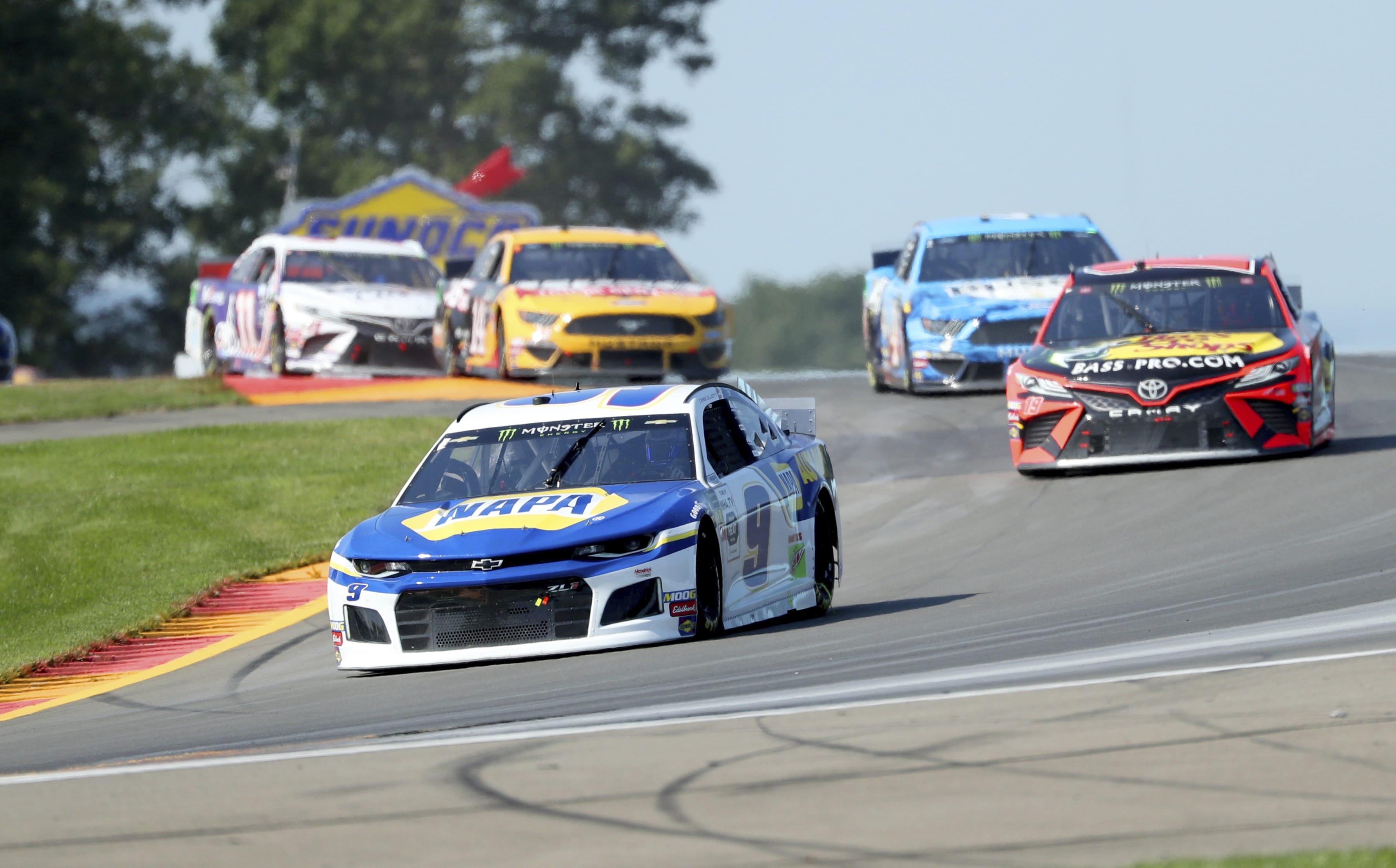 Chase Elliott leads the field thought the area known as "The Bus Stop" during a NASCAR Cup Series auto race at Watkins Glen International, Sunday, Aug. 4, 2019, in Watkins Glen, N.Y.
