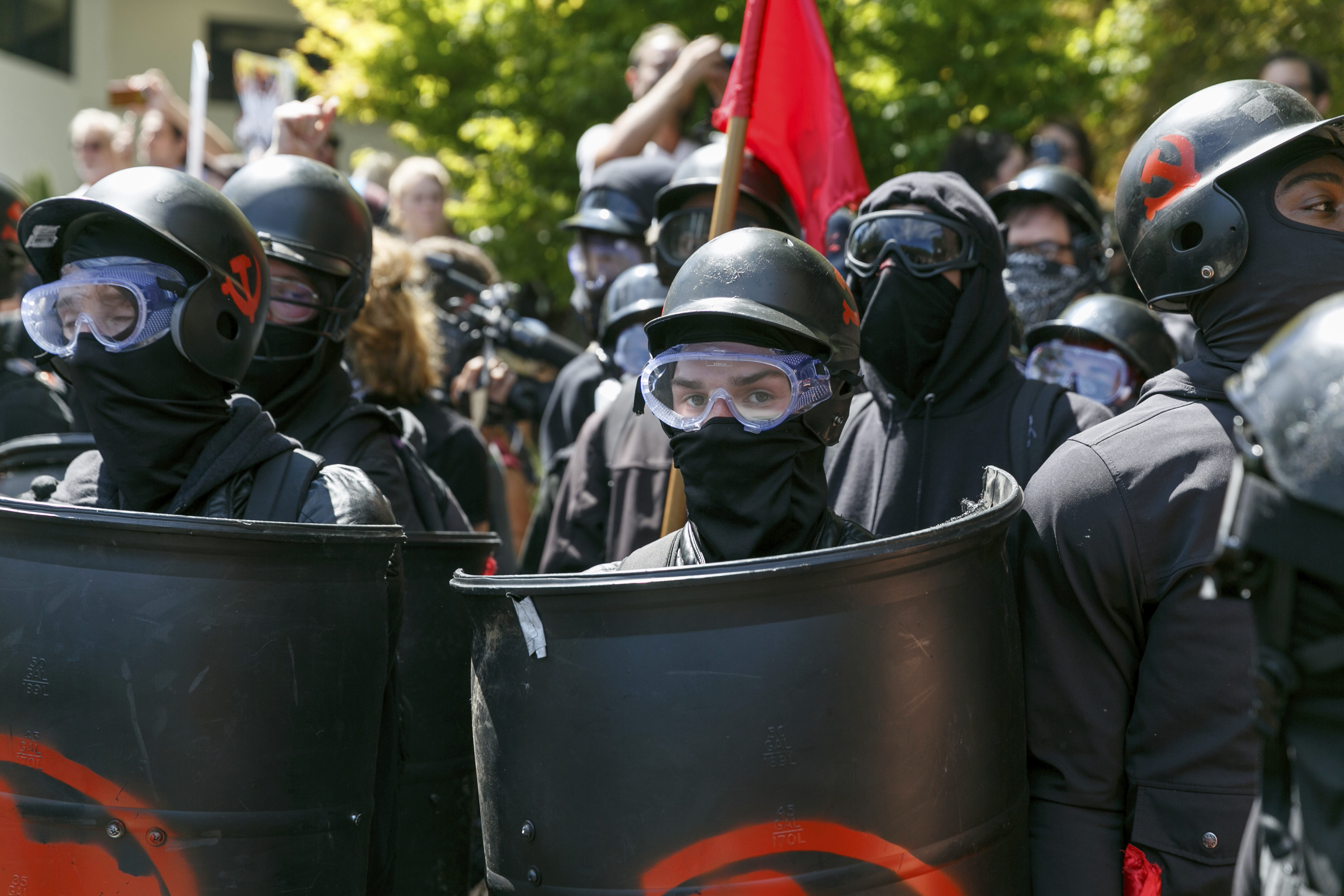 FILE - In this Aug. 4, 2018, file photo, counter-protesters prepare to clash with Patriot Prayer protesters during a rally in Portland, Ore. Portland police are mobilizing in hopes of avoiding clashes between out-of-state hate groups planning a rally Saturday, Aug. 17, 2019, and homegrown anti-fascists who say they’ll come out to oppose them. Since President Donald Trump’s election, Portland has become a political arena for far-right and far-left groups to face off.