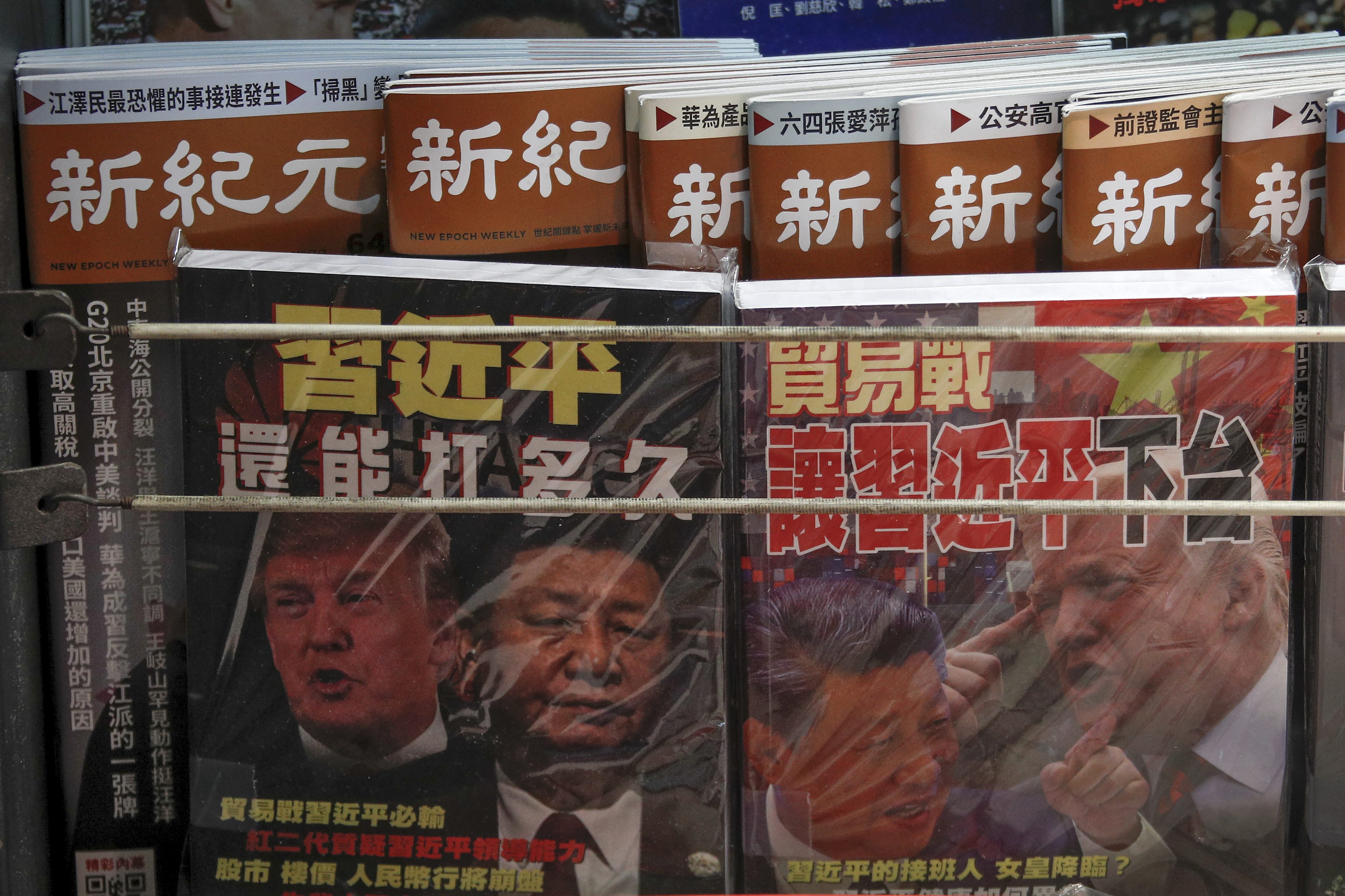 In this July 4, 2019, photo, Chinese magazines with front covers featuring Chinese President Xi Jinping and U.S. President Donald Trump on trade war is placed on sale at a roadside bookstand in Hong Kong. Facing another U.S. tariff hike, Xi is getting tougher with Washington instead of backing down. Both sides have incentives to settle a trade war that is battering exporters on either side of the Pacific and threatening to tip the global economy into recession.