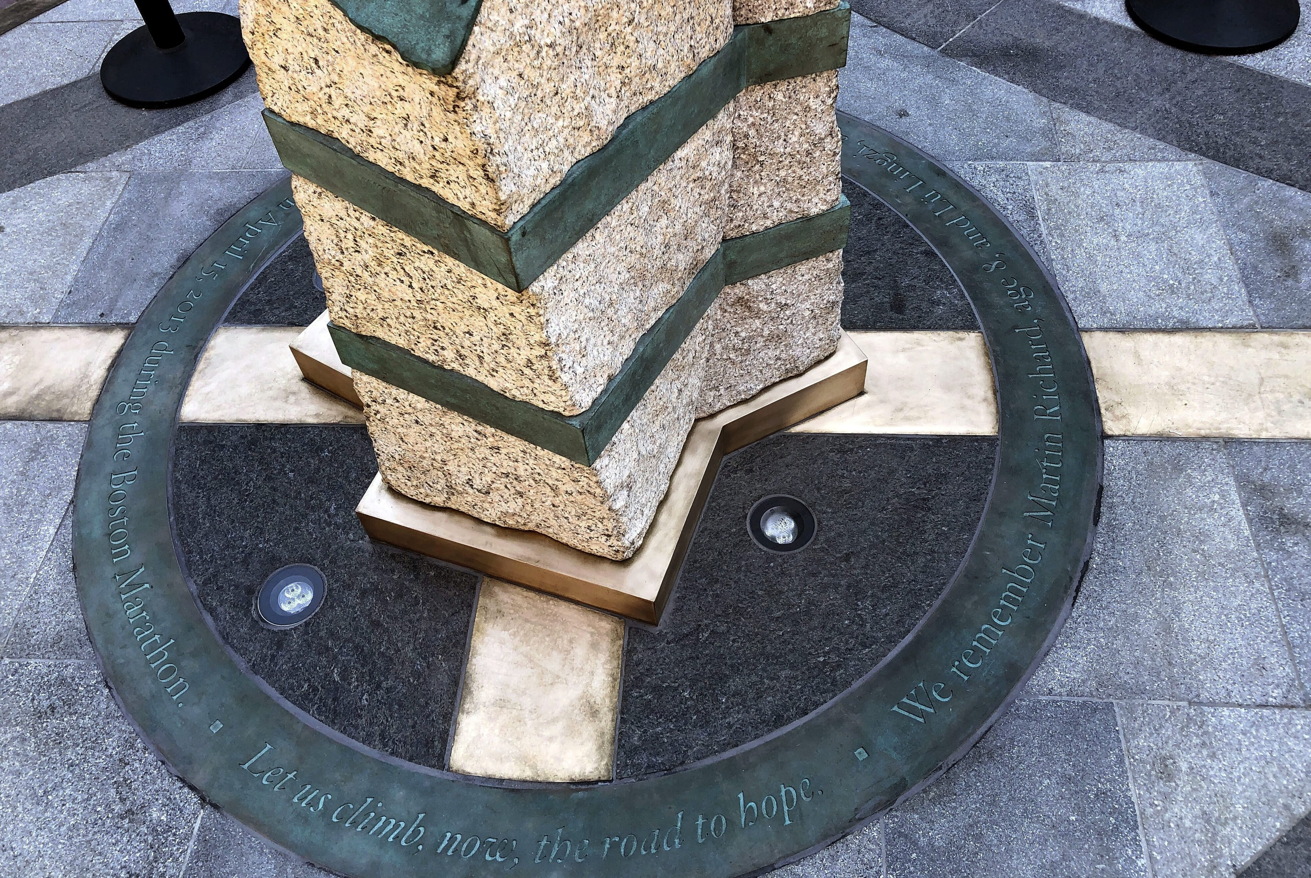 Inscriptions ring the base of two of the stone pillars completed Monday, Aug. 19, 2019, in Boston to memorialize the Boston Marathon bombing victims at the sites where they were killed. Martin Richard, Krystle Campbell and Lingzi Lu were killed when bombs were detonated at two locations near the finish line on April 15, 2013.