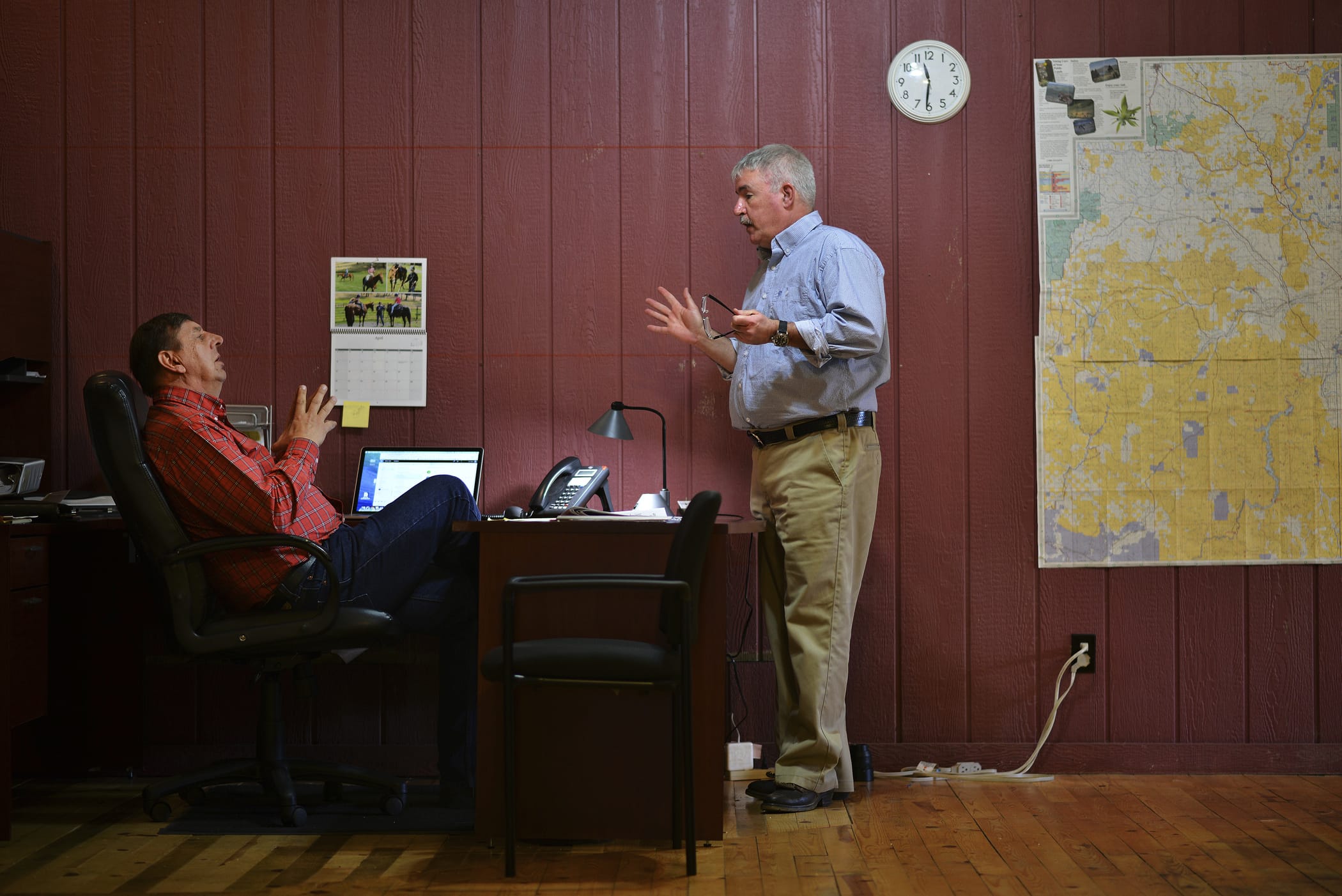 In this Monday, April 16, 2018, photo reporter Pat Caldwell, right, talks to Malheur Enterprise Publisher Les Zaitz about a story he is developing while working on deadline for the newspaper in Vale, Ore. Journalists in Oregon and beyond have risen in defense of a small newspaper that is being investigated by a county sheriff for trying to get comments after business hours for an investigative story. Staffers at the Malheur Enterprise, a weekly newspaper in the remote eastern Oregon town of Vale, say they are just doing their job.  (E.J.