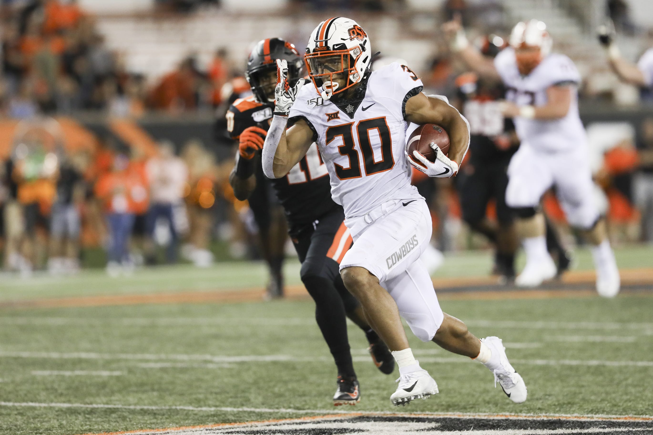Oklahoma State wide receiver Chuba Hubbard (30) sprints up the field during the second half of an NCAA college football game with Oregon State in Corvallis, Ore., Friday, Aug. 30, 2019. Oklahoma State won 52-36.