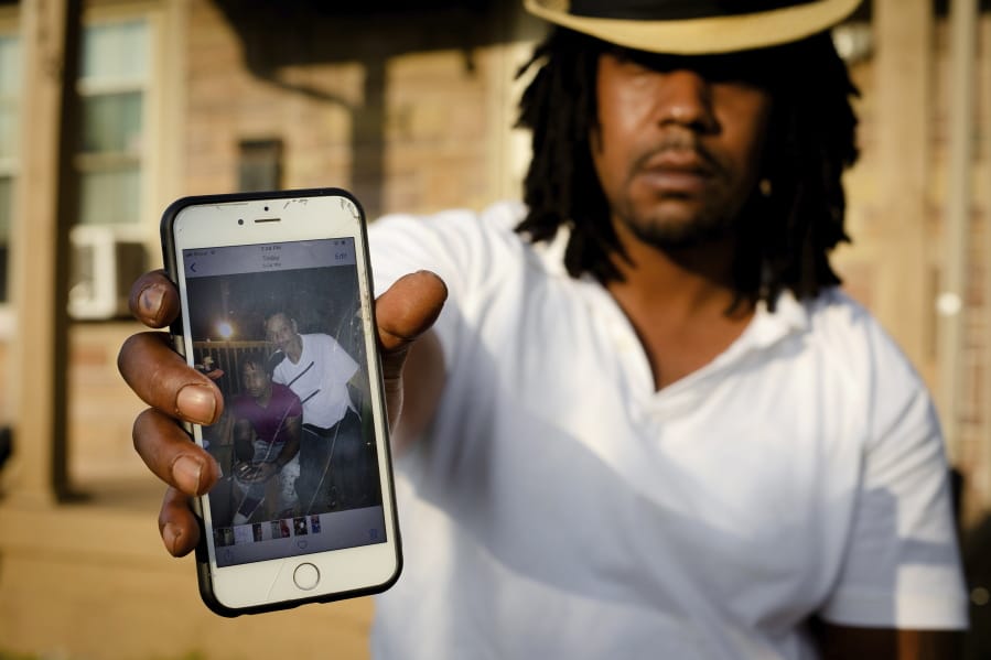 Dion Green holds a cell phone showing a picture of himself and his father, Derrick Fudge, who was killed in Sunday’s mass shooting in Dayton, Ohio, at his home on Tuesday, Aug. 6, 2019 in Dayton. Green just wanted to have some fun with his family in downtown Dayton after what had been a tough couple of months in the aftermath of damaging tornadoes. But his Saturday night out ended tragically, with his father dying in his arms, his eyes looking into his as he took his final breath.