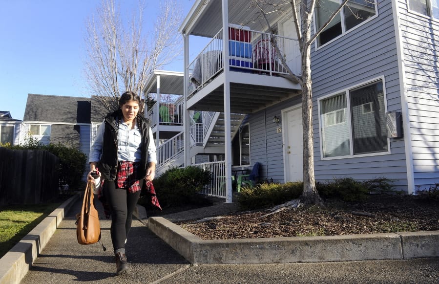 Monica Magdaleno leaves her apartment Dec. 7, 2017, on Garfield Street in Ashland, Ore. Gov. Kate Brown signed a first-in-the-nation law Thursday to encourage the development of duplexes, triplexes and other more affordable types of housing.