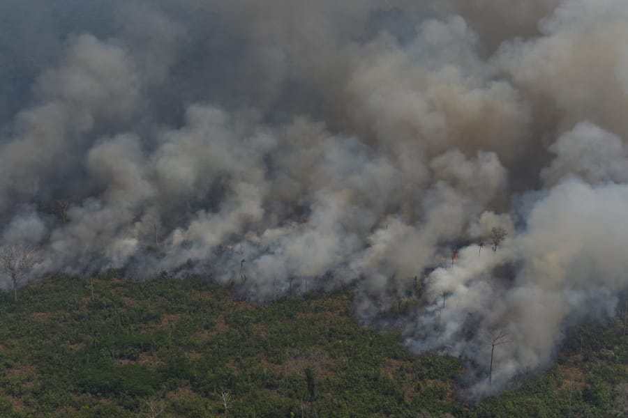 Wildfires consume an area near Porto Velho, Brazil, Friday, Aug. 23, 2019. Brazilian state experts have reported a record of nearly 77,000 wildfires across the country so far this year, up 85% over the same period in 2018. Brazil contains about 60% of the Amazon rainforest, whose degradation could have severe consequences for global climate and rainfall. (AP Photo/Victor R.
