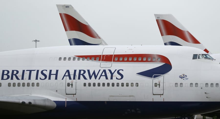 FILE - This Jan. 10, 2017 file photo, British Airways planes are parked at Heathrow Airport in London. British Airways said Wednesday Aug.