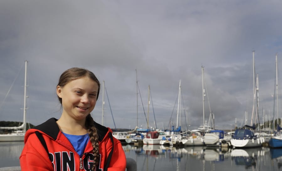 Greta Thunberg poses for a picture in the Marina where the boat Malizia is moored in Plymouth, England Tuesday, Aug. 13, 2019. Greta Thunberg, the 16-year-old climate change activist who has inspired student protests around the world, is heading to the United States this week - in a sailboat.