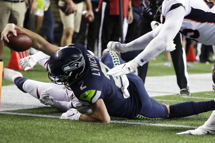 Seattle Seahawks quarterback Paxton Lynch scores a touchdown against the Denver Broncos during the second half of an NFL football preseason game Thursday, Aug. 8, 2019, in Seattle.