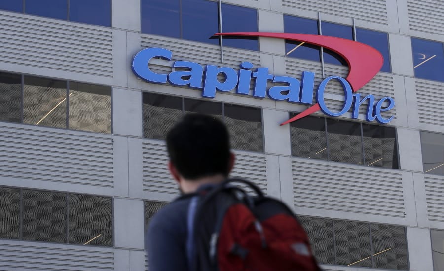 A man walks across the street from a Capital One location on July 16 in San Francisco.