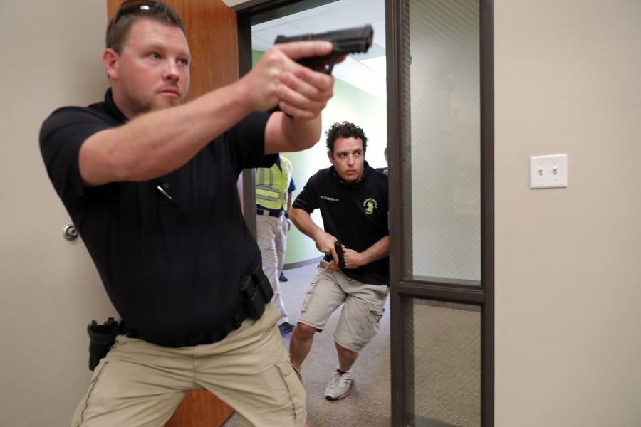 Trainees Chris Graves, left, and Bryan Hetherington participate in a security training session July 21 at Fellowship of the Parks campus in Haslet, Texas.