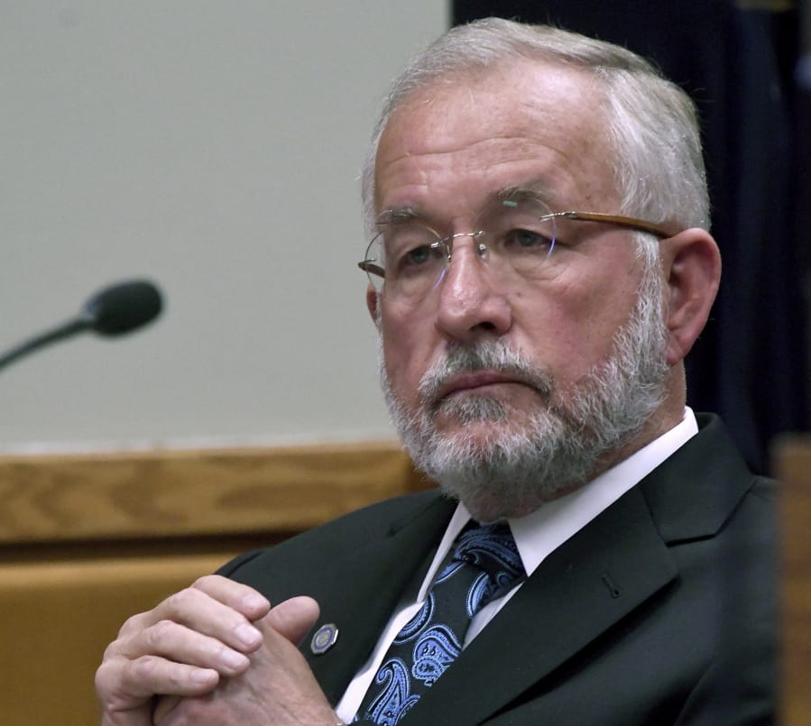 FILE- In this June 5, 2018, file photo, former Michigan State University dean William Strampel watches court proceedings at his preliminary exam in East Lansing, Mich. Sentencing is scheduled for the former dean who had oversight of now-imprisoned sports doctor Larry Nassar at Michigan State University. Strampel goes back before a judge Wednesday, Aug. 7, 2019, nearly two months after the College of Osteopathic Medicine's ex-dean was convicted of neglect of duty and misconduct in office. (Dale G.