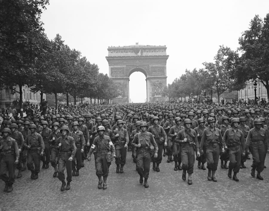 U.S. soldiers of Pennsylvania’s 28th Infantry Division march along the Champs Elysees on Aug. 29, 1944, with the Arc de Triomphe in the background, four days after the liberation of Paris.