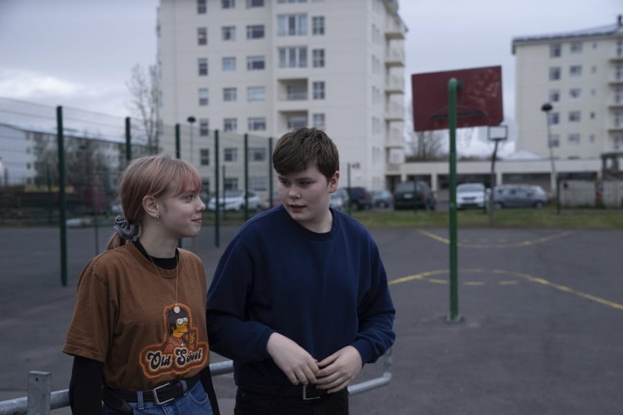 Karen Guttensen and Ingvar Ingolfsson, right, both 14 years old, spend time outside the Tjornin youth center May 13 in Reykjavik, Iceland, on a bright summer night.