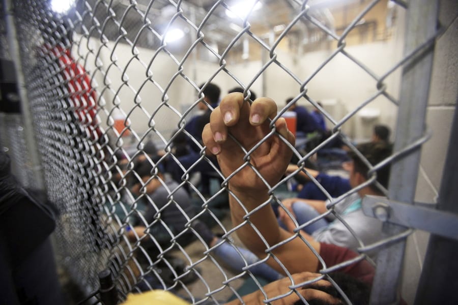 Detained Immigrants wait in a holding cell at the Border Patrol’s processing center in McAllen, Texas, Monday, Aug. 12, 2019.
