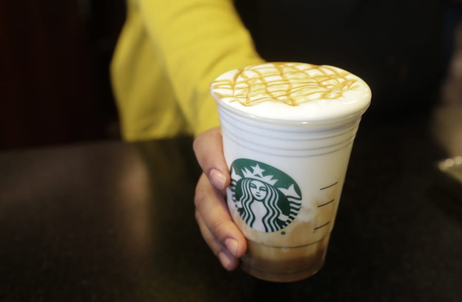 Esmeralda Chapparro, a Starbucks barista, moves a finished Cloud Macchiato coffee drink to the counter as she works at a store in the company’s headquarters building in Seattle’s SODO neighborhood. Ted S.