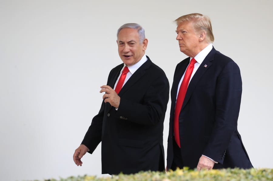 Visiting Israeli Prime Minister Benjamin Netanyahu and President Donald Trump walk along the Colonnade of the White House in Washington on March 25.