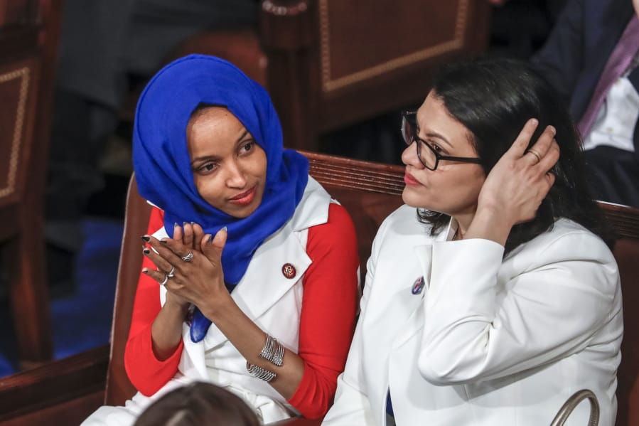 FILE - In this Feb. 5, 2019 file photo, Rep. Ilhan Omar, D-Minn., left, joined at right by Rep. Rashida Tlaib, D-Mich., listen to President Donald Trump’s State of the Union speech, at the Capitol in Washington. Israel’s prime minister is holding consultations with senior ministers and aides to reevaluate the decision to allow two Democratic Congresswomen to enter the country next week. A government official said Thursday, Aug. 15, 2019, that Benjamin Netanyahu was holding consultations about the upcoming visit of Omar and Tlaib, and that “there is a possibility that Israel will not allow the visit in its current proposed format.” (AP Photo/J.
