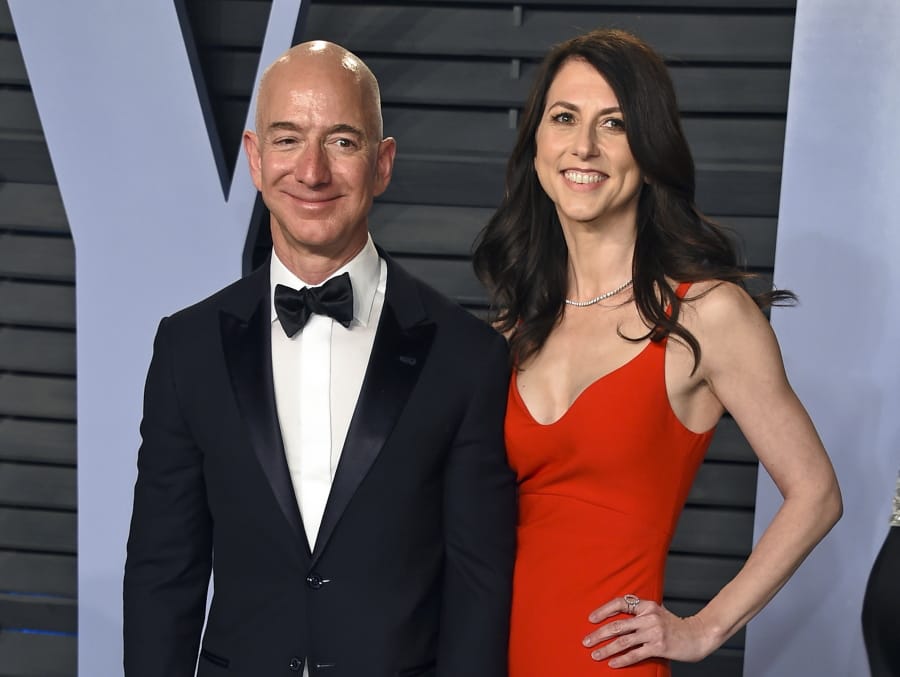 FILE - In this March 4, 2018 file photo, Jeff Bezos and wife MacKenzie Bezos arrive at the Vanity Fair Oscar Party in Beverly Hills, Calif. Amazon founder Jeff Bezos and his ex-wife, MacKenzie Bezos, have divided up their stake in Amazon. In a government filing late Wednesday, July 31, 2019, Amazon disclosed that Jeff Bezos now has an 11.8% in the company worth nearly $110 billion after completing the divorce and cashing in some $2 billion worth of stock.