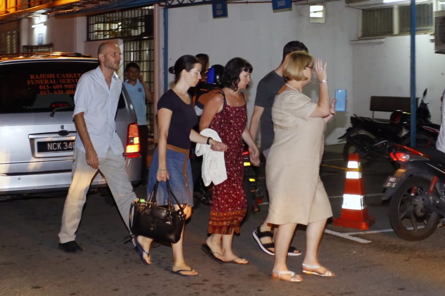 Family members of missing British girl Nora Anne Quoirin arrive at a hospital morgue in Seremban, Negeri Sembilan, Malaysia, Tuesday, Aug. 13, 2019. Malaysian police say the family of a missing 15-year-old London girl has positively identified a body found near the nature resort where she disappeared over a week ago.